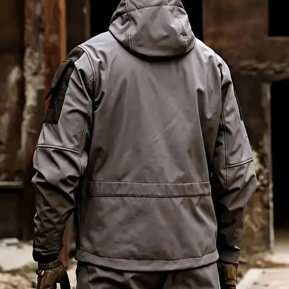 Back of the grey softshell jacket worn with the hood up and a black upper-sleeve panel; gloves and trousers not included