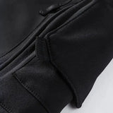 Close-up of a zipped pocket under a flap on the black jacket's sleeve