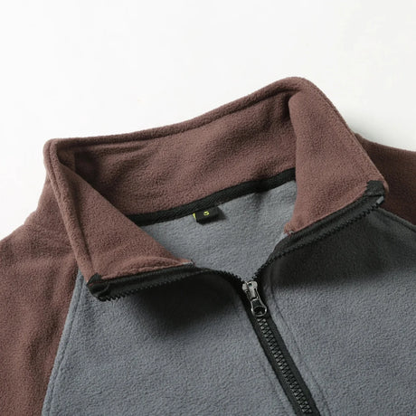 Close-up of the stand collar and half zip, coffee collar on a grey body