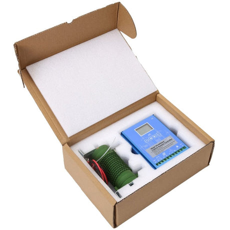 The blue hybrid controller and its green dump-load resistor packed in foam inside their open cardboard shipping box.