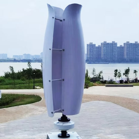 The white tulip turbine on its base in a riverside park, with apartment towers across the water behind - the White colourway.