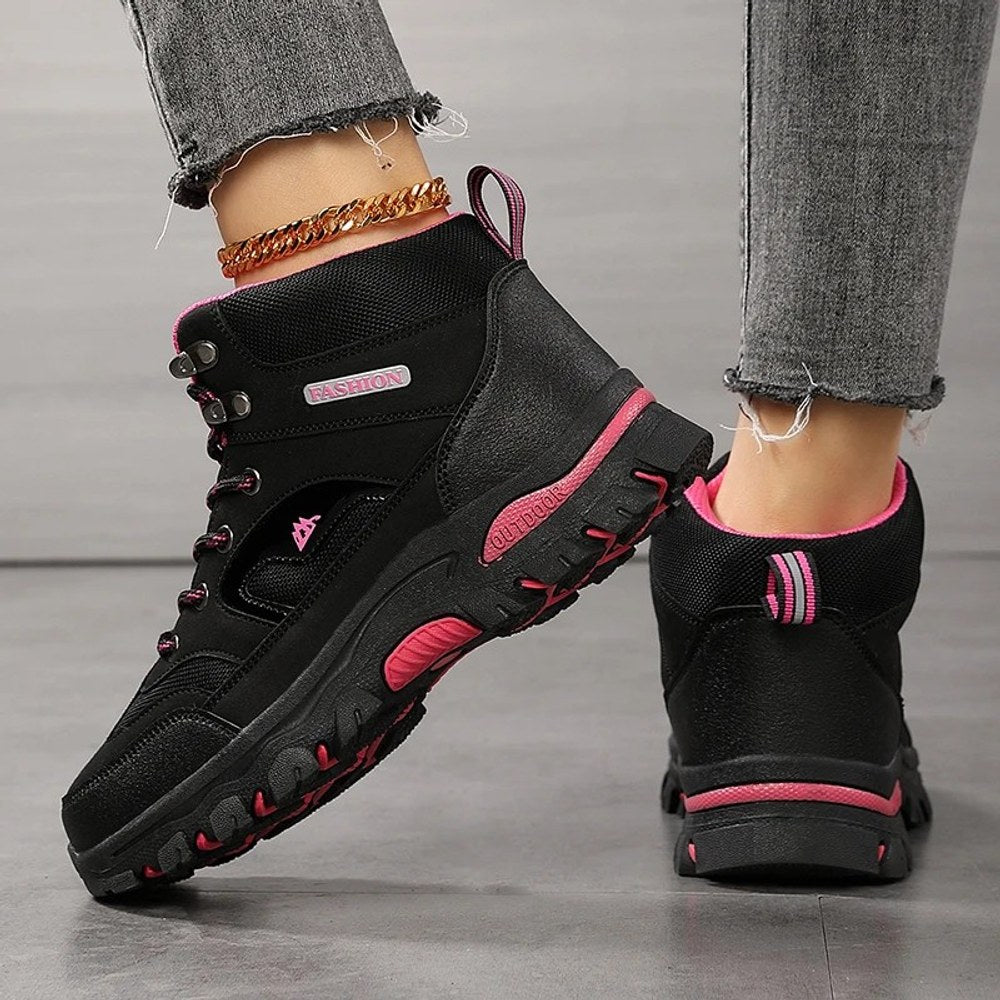 Black hiking boot from the back and side: heel pull loop, mesh collar and rose red sole strip