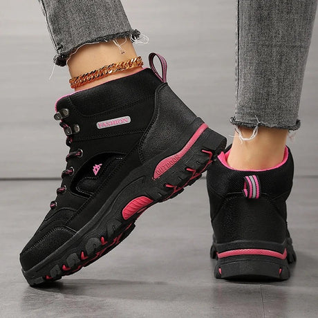 Black hiking boot from the back and side: heel pull loop, mesh collar and rose red sole strip