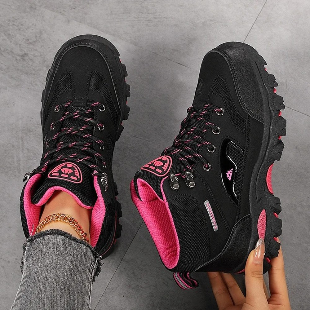 Black and rose red hiking boots from above, showing the laces, speed hooks, padded collar and rose red lining