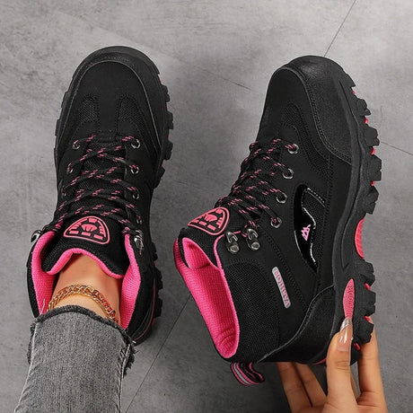 Black and rose red hiking boots from above, showing the laces, speed hooks, padded collar and rose red lining