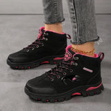 Black and rose red hiking boots worn, showing the lace-up front and rubber lug outsole