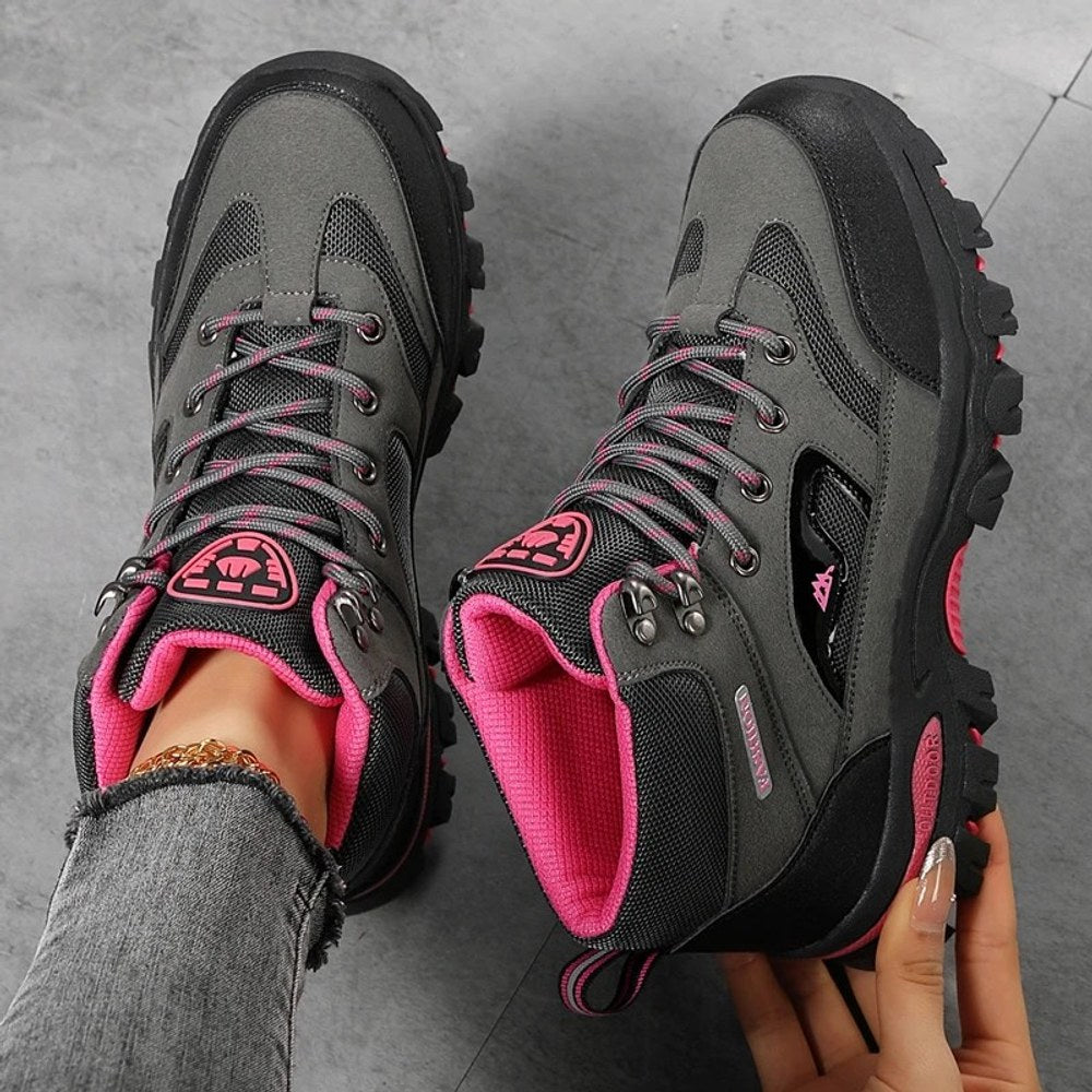 Grey and rose red hiking boots from above, showing the laces, mesh tongue, padded collar and rose red lining