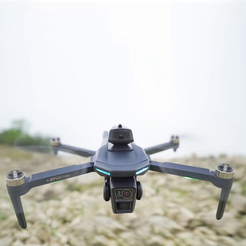 XT606 drone hovering close up, its dual front camera and the sensor head on top facing the camera