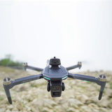 XT606 drone hovering close up, its dual front camera and the sensor head on top facing the camera