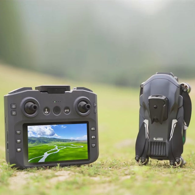 XT606 screen remote showing its live view, standing on grass beside the folded XT606 drone