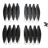 Sixteen black XT606 drone propellers with white tips and their mounting screws