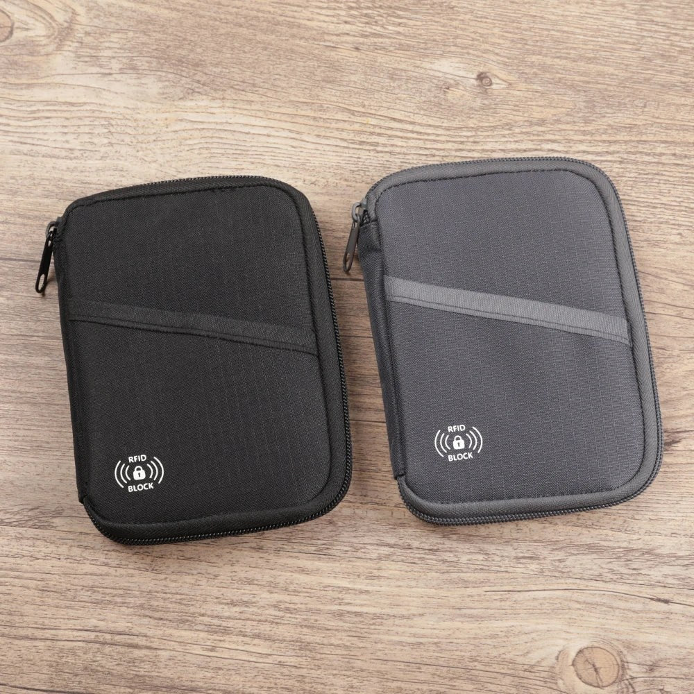 The black and grey pouches side by side on a wooden desk