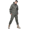 Grey-green softshell set, studio, hood down and one hand in a trouser pocket