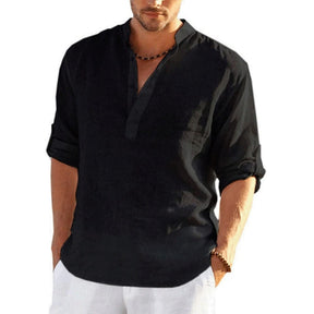 Black band collar shirt on a model, sleeves rolled up, worn loose over white trousers