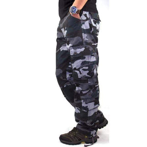 Blue-grey camo cargo pants side view, thigh cargo pocket and hem gathered over a boot