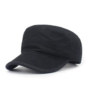 Black flat-top cadet cap at a three-quarter angle, showing the flat crown and stitched panel seams