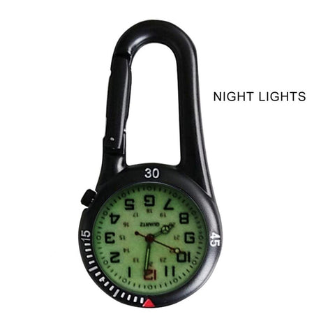Black clip watch glowing in low light, captioned Night Lights, hands and numerals lit pale green