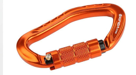 Close-up of an orange carabiner on its side, knurled sleeve in focus